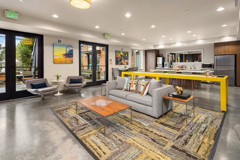 a living room with a gray couch and a yellow table